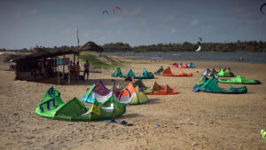 Different Kite Sizes Kitesurfs Spread out on the Sandy Beach