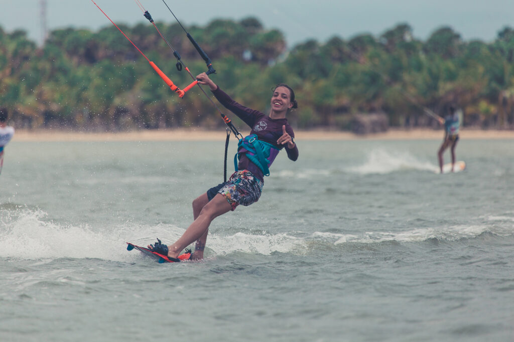 kitesurfing girl feels good and shows that everything is fine